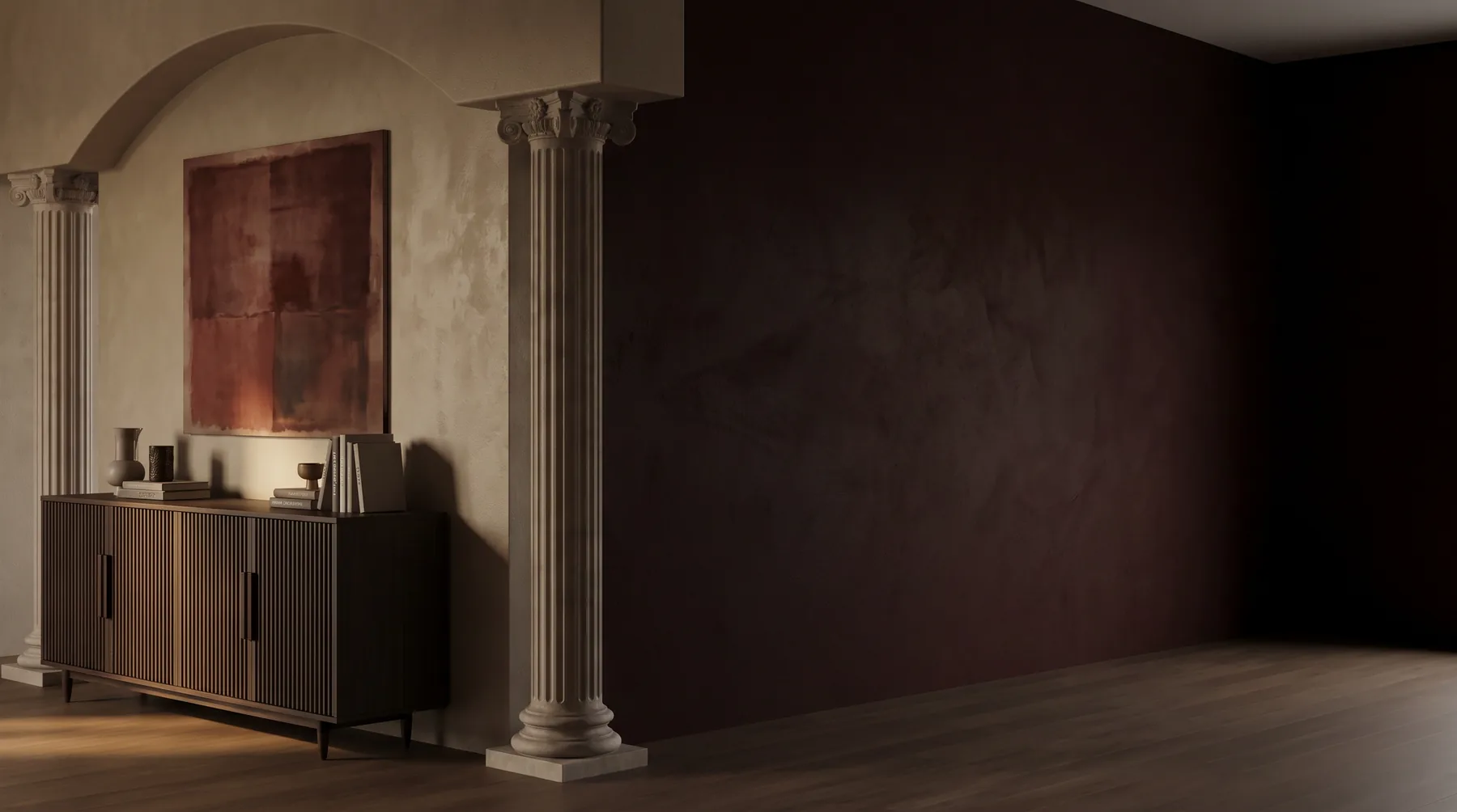Fluted cast stone columns with carved capitals framing an arched alcove in a dark-walled interior
